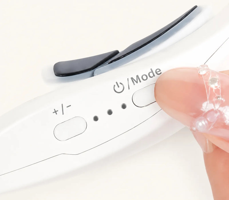 Close-up of a white handheld electronic device with a black slider, plus/- and Mode buttons, and a finger pressing the Mode button.