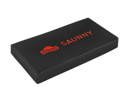 Angled view of the SAUNNY sauna blanket pillow showing its sleek rectangular design and ergonomic form