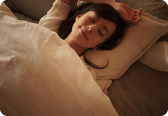 Woman sleeping peacefully on a pillow with soft lighting