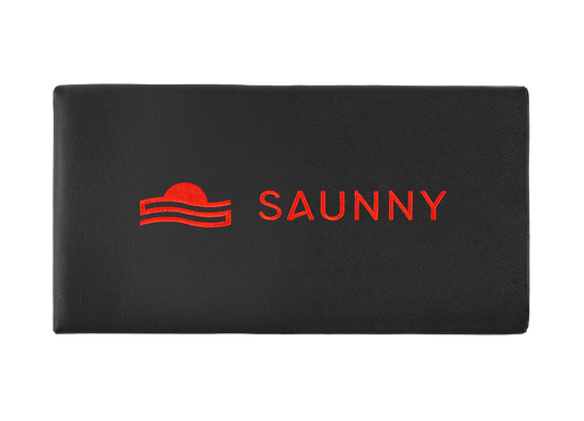 SAUNNY sauna blanket pillow top view, featuring the logo on black premium PU leather surface